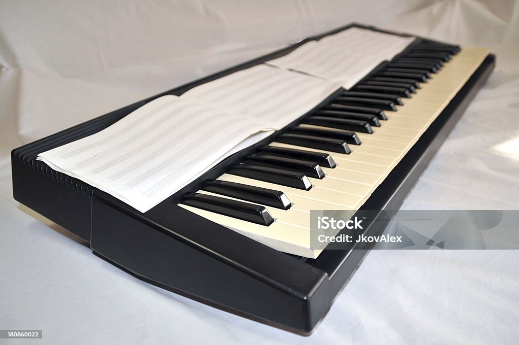 Old keyboards Oblique view of the old keyboards ready for playing and composing. Bass Guitar Stock Photo