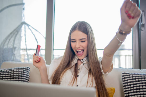 istock Happy young customer enjoys shopping online 1808600976