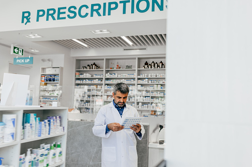 Doctor is explaining to the patient information about the use of the drug, the indication, how to take it side effect of the drug and the patient's medication history record.