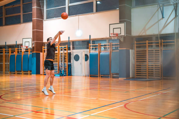 istock Caucasian Male Basketball Player Practicing Free Throws 1808634747