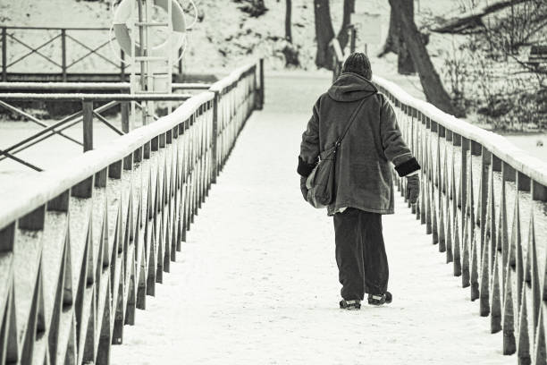 istock a person walking on a snow covered bridge 1808638478