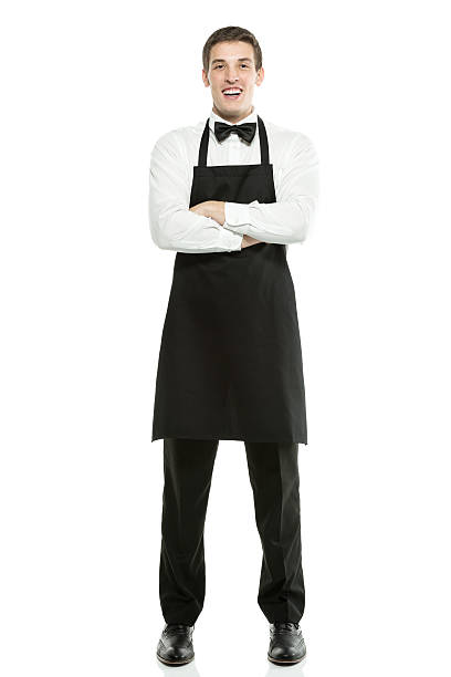 istock Smiling young waiter with his arms crossed 180865139