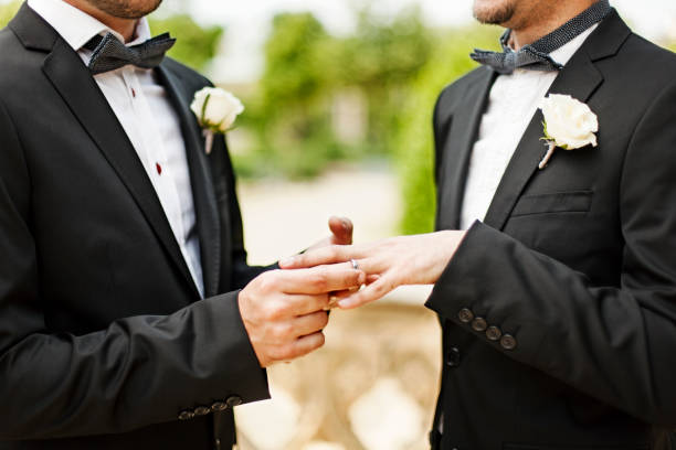 Homosexual couple wedding ceremon Gay Couple Exchanging Rings at Wedding marriage equality stock pictures, royalty-free photos & images