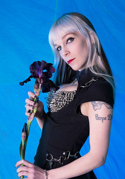 istock Woman with two tone hair holding black iris. 180865232