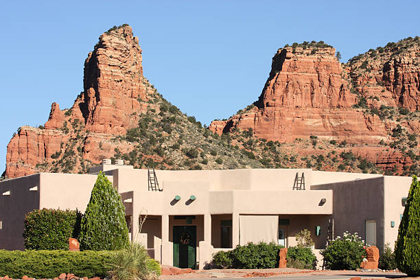 Villa Mansion Home Southwest Desert Living Santa Fe styled desert Southwest mansion with eroded red rock buttes in the background.  Yavapai County, Arizona, 2013. nook architecture photos stock pictures, royalty-free photos & images