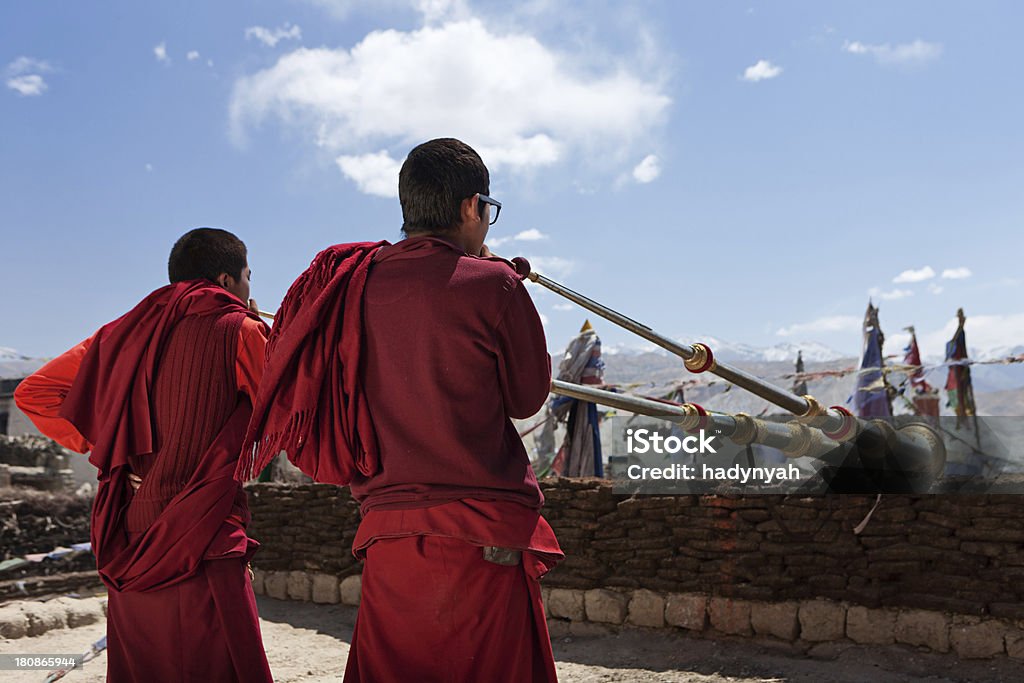 Tibetan monks playing buddhist horns Mustang region is the former Kingdom of Lo and now part of Nepal,  in the north-central part of that country, bordering the People's Republic of China on the Tibetan plateau between the Nepalese provinces of Dolpo and Manang. The Kingdom of Lo, the traditional Mustang region, and “Upper Mustang” are one and the same, comprising the northern two-thirds of the present-day Nepalese Mustang District, and are well marked by official “Mustang” border signs just north of Kagbeni where a police post checks permits for non-Nepalese seeking to enter the region, and at Gyu La (pass) east of Kagbeni.http://bem.2be.pl/IS/mustang_380.jpg Monk - Religious Occupation Stock Photo