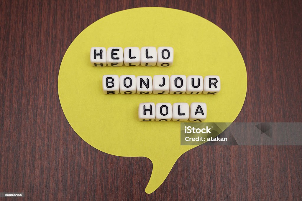 Hello Bonjour Hola Hello Bonjour Hola Dice Letter on table Greeting Stock Photo