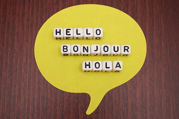 Hello Bonjour Hola Dice Letter on table