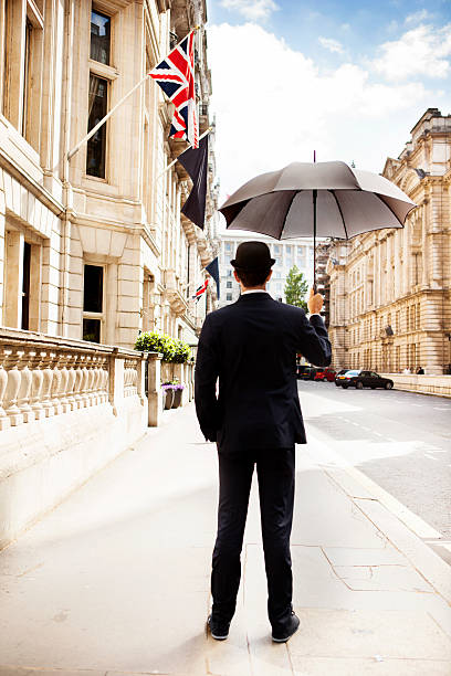 Man with opened umbrella looking at the city Man with opened umbrella looking at the city derby city stock pictures, royalty-free photos & images