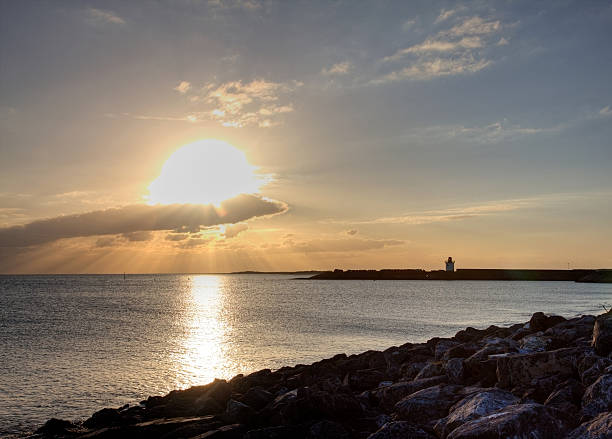 istock Burry Port lighthouse and harbour at sunset 180866354