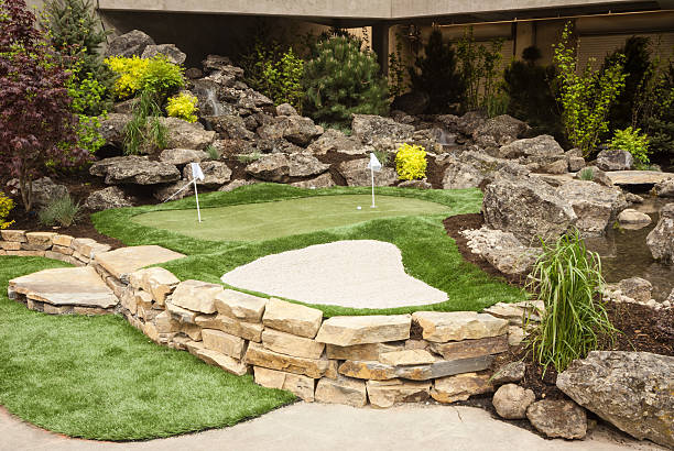 Putting Green with Sand Pit This home back yard has a putting green and a sand pit.  putting green stock pictures, royalty-free photos & images