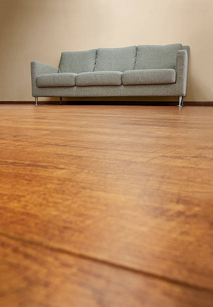 Fabric couch on wooden floor stock photo