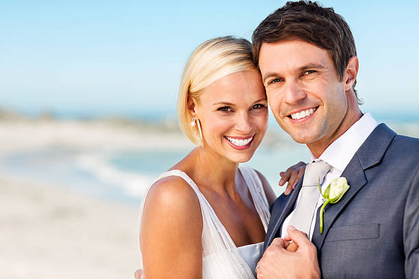 istock Newlywed Bride And Groom Smiling Together On Beach 180867819