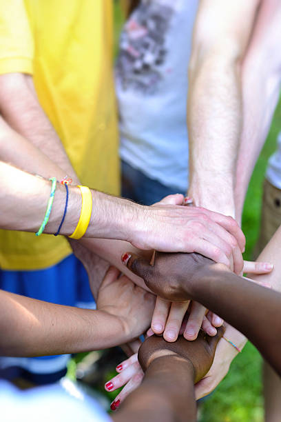 istock Close-up of team joining hands 180867861