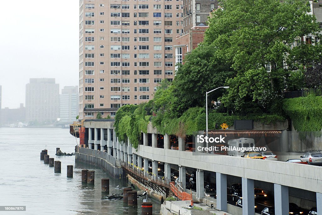 Traffic on FDR Drive along the East River in NYC Heavy traffic moves on the FDR Drive North on the Upper East Side of New York City along the East River Apartment Stock Photo