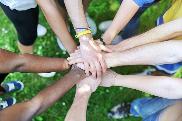 istock Young adult team joining hands 180867909