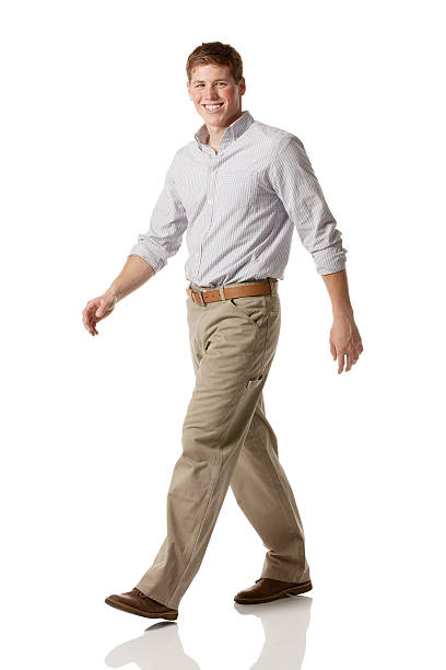 istock Smiling businessman walking against white 180868077