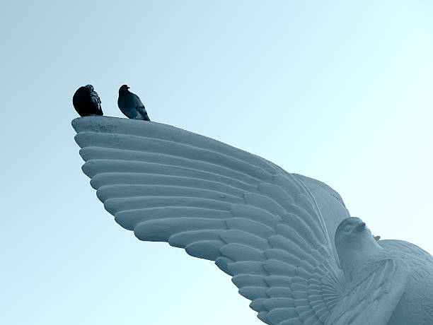 istock Tow pigeons sitting on a pigeon statue 180868528