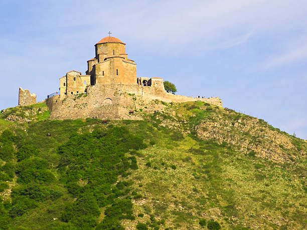 The orthodox monastery of Jvari or Monastery of the Cross, from the 6th century, on the top of hill, near Mtskheta, Georgia. People are too small to be recognizable