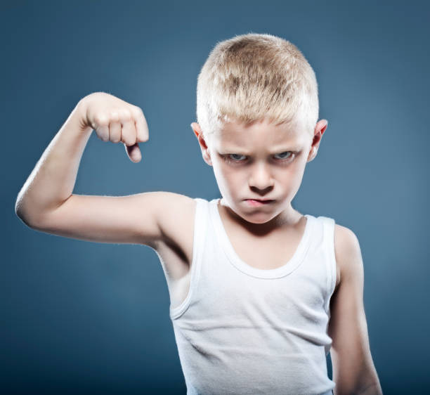 istock Young child showing his muscles 180869577