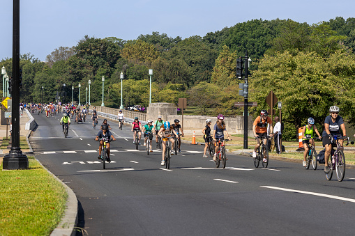 In the picture, a group of cyclists are seen participating in the 7th annual DC Bike Ride on September 9th, 2023. The ride spans 20 miles of car-free streets across the District and Northern Virginia, with the route stretching from the Tidal Basin, crossing the Arlington Memorial to Georgetown and ending up near the U.S. Capitol on Pennsylvania Avenue. The cyclists are seen riding in near the U.S. Capitol Building, which is a popular tourist attraction in Washington D.C. The event is expected to attract thousands of riders of all ages and riding abilities. It is a great way to enjoy the city’s famous sights while having fun on two wheels.