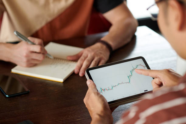 istock Businessmen Analyzing Stock Market Graph 1808734540