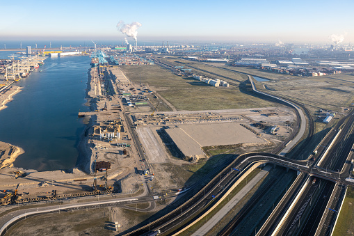 Aerial view Industrial area Maasvlakte Port of Rotterdam with freeway, cranes and storage area sea containers