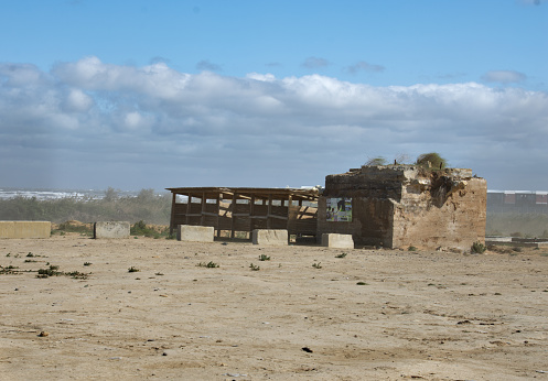 Destroyed building on the sandy seashore