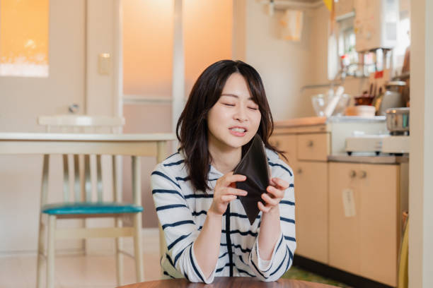 istock A depressed young woman checking her purse 1808743895