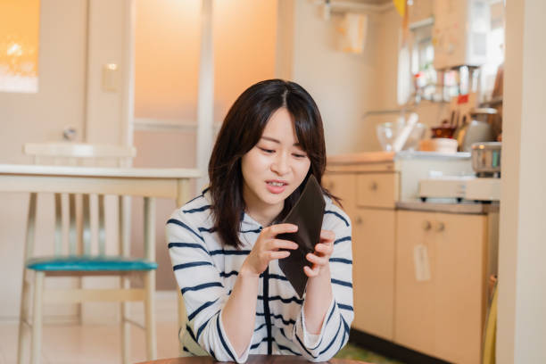 istock A depressed young woman checking her purse 1808743914