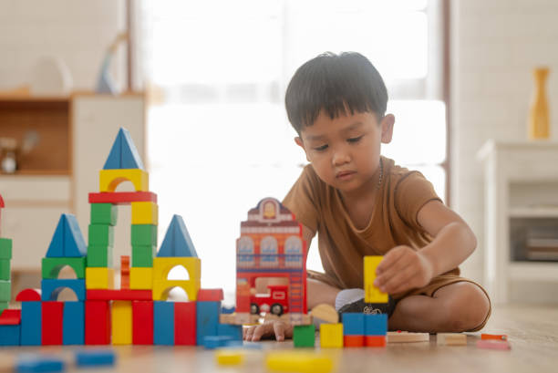 istock Cute little boy playing with wooden train 1808752461