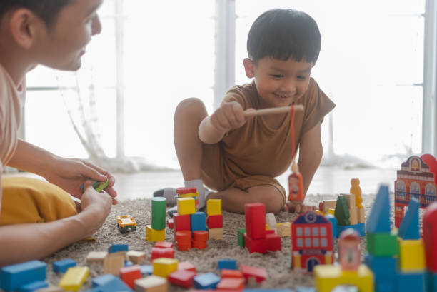 istock Cute little boy playing with wooden train 1808753065