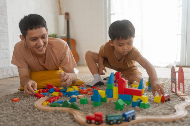 istock Cute little boy playing with wooden train 1808753087
