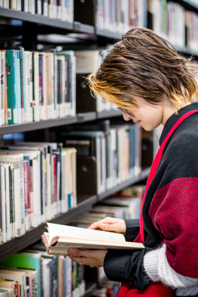istock Modern Identity: Gender Non-Conforming Teen Explores the Library 1808755342