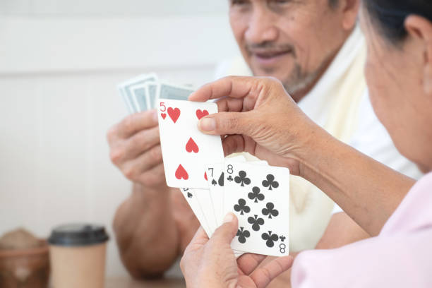 istock Elderly people playing cards. 1808765669