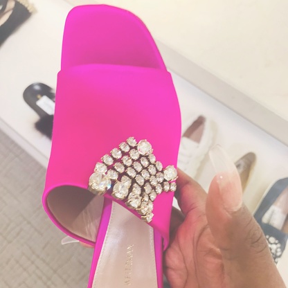A Hot Pink Sandal with Crystals, in a shoe/department store.