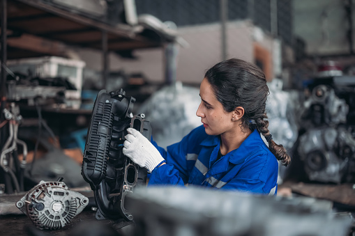 Car service technicians expertly inspect, assess engine parts in storage. Carefully selecting quality gears and instruments for precise repairs, modify, assembly. Assuring optimal vehicle performance