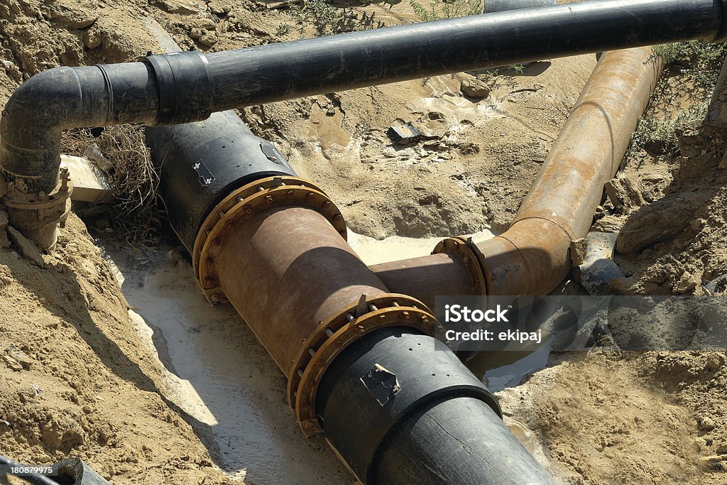 Plastic pipes in the ground. Compound plastic pipe in the trench, a top view Built Structure Stock Photo