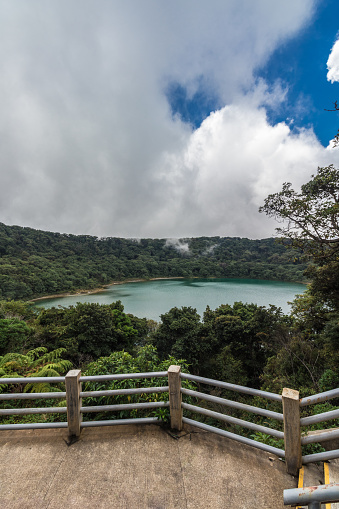 Vertical shot of Laguna Botos viewpoint turquoise acidic waters in the PoÃ¡s Volcano National Park in Costa Rica on a cloudy morning