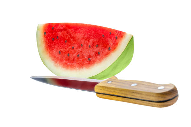 A slice of fresh watermelon on the kitchen table, close-up view.
