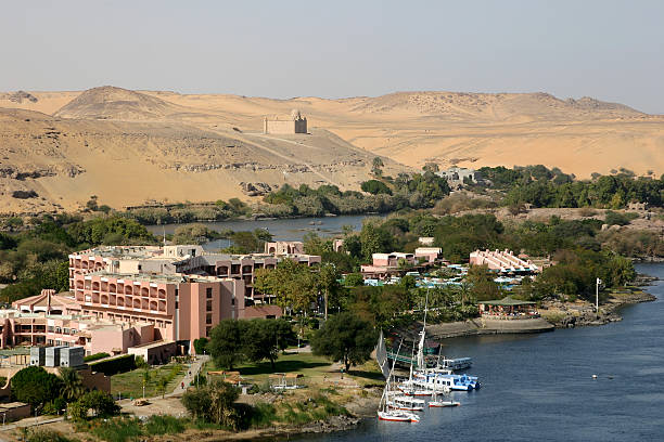 Aswan A view of the Nile in Aswan with the mausoleum of the Aga Khan in the background. aga khan iv stock pictures, royalty-free photos & images