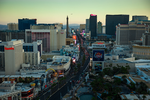 Aerial shot of Las Vegas taken in the evening. All logos removed. Vibrant multi colored lights are glowing against a pitch black evening sky. Taken with Canon 5D Mark lV.