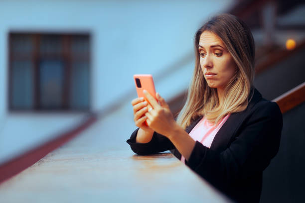 Puzzled Businesswoman reading a Text Message on her Smartphone