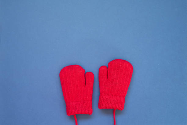 istock Winter knitted fur wool red gloves on navy blue background. top view, copy space 1808881996