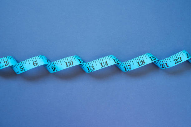 istock Tape measure on navy blue background. top view 1808882009