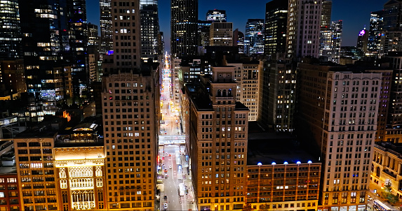 Aerial still image of Madison Street in downtown Chicago, Illinois at night in Fall.