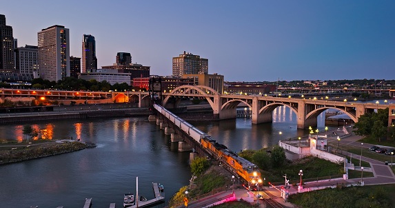 Aerial still image of train crossing Mississippi River from downtown St. Paul, Minnesota at twilight in Fall.

Authorization was obtained from the FAA for this operation in restricted airspace.