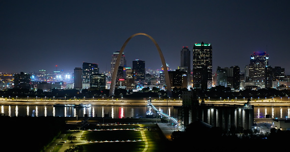 Drone shot of St. Louis, Missouri on a a hazy night in Fall, looking across the Mississippi River from the Illinois side towards downtown office towers and the Gateway Arch. 

Authorization was obtained from the FAA for this operation in restricted airspace.