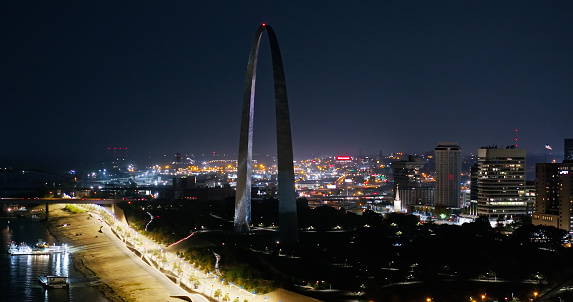 Aerial still image of The Gateway Arch taken by a drone on a hazy night in St. Louis, Missouri.