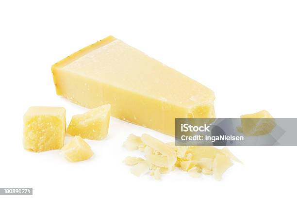 Slice And Crumbs Of Lightyellow Parmesan Cheese Stock Photo - Download Image Now - Parmesan Cheese, Wood Shavings, White Background